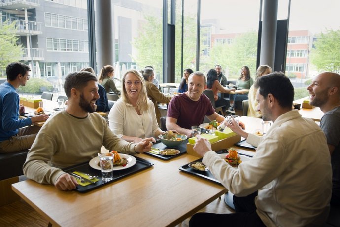A group of Vector employees sit at a table and eat a delicious lunch.