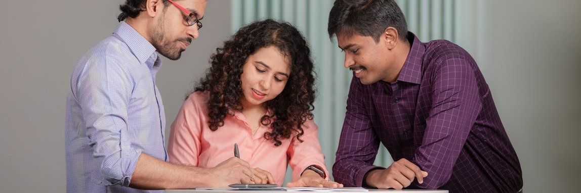 3 Vector Employees discussing in the office