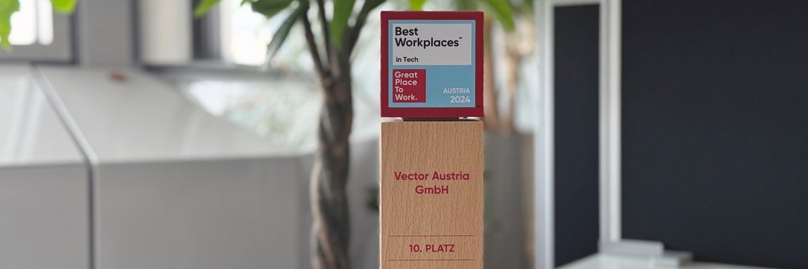 Wooden trophy in an office with green plants. It is the “Best Workplaces in Tech 2024” award. 