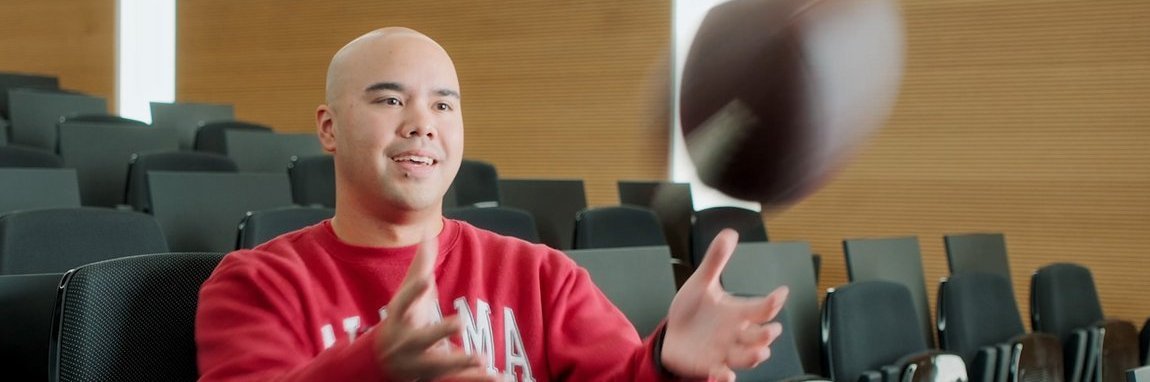 A Vector employee catches an American football.