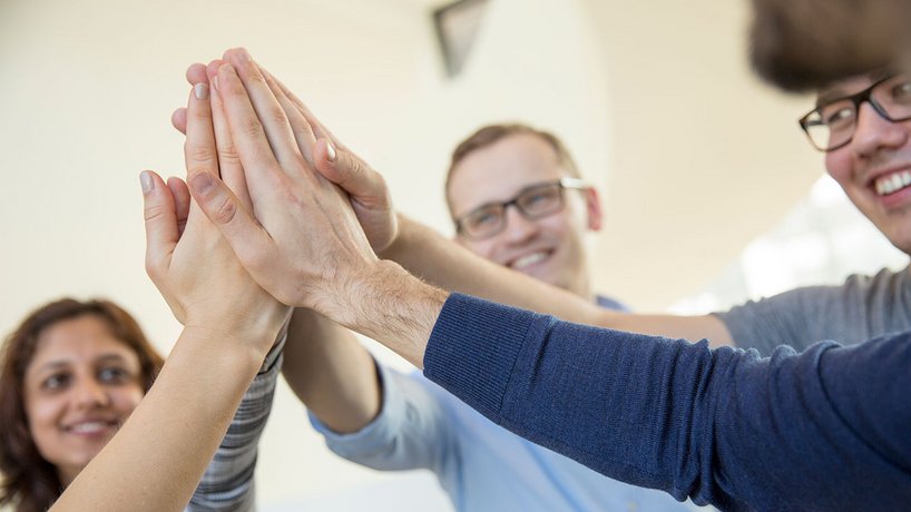 Vector employees give themselves a high five