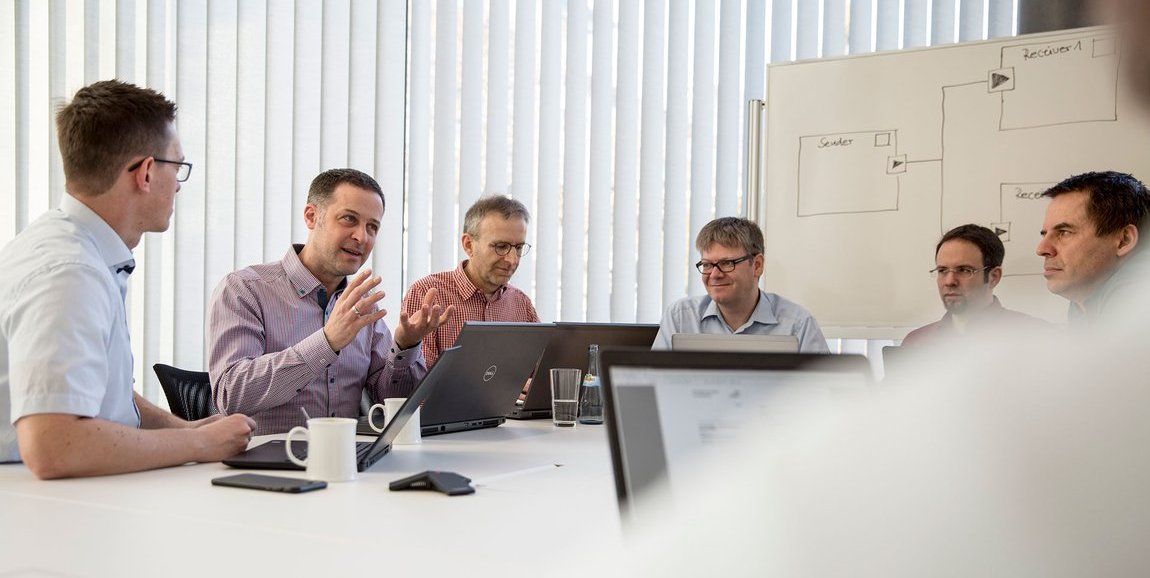 Vector employees in a technical discussion