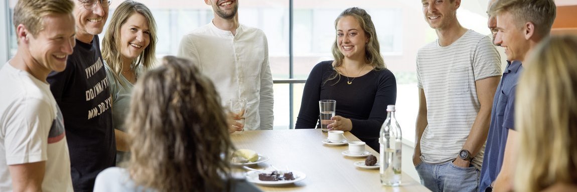 Vector employees in a modern office talking around a table 