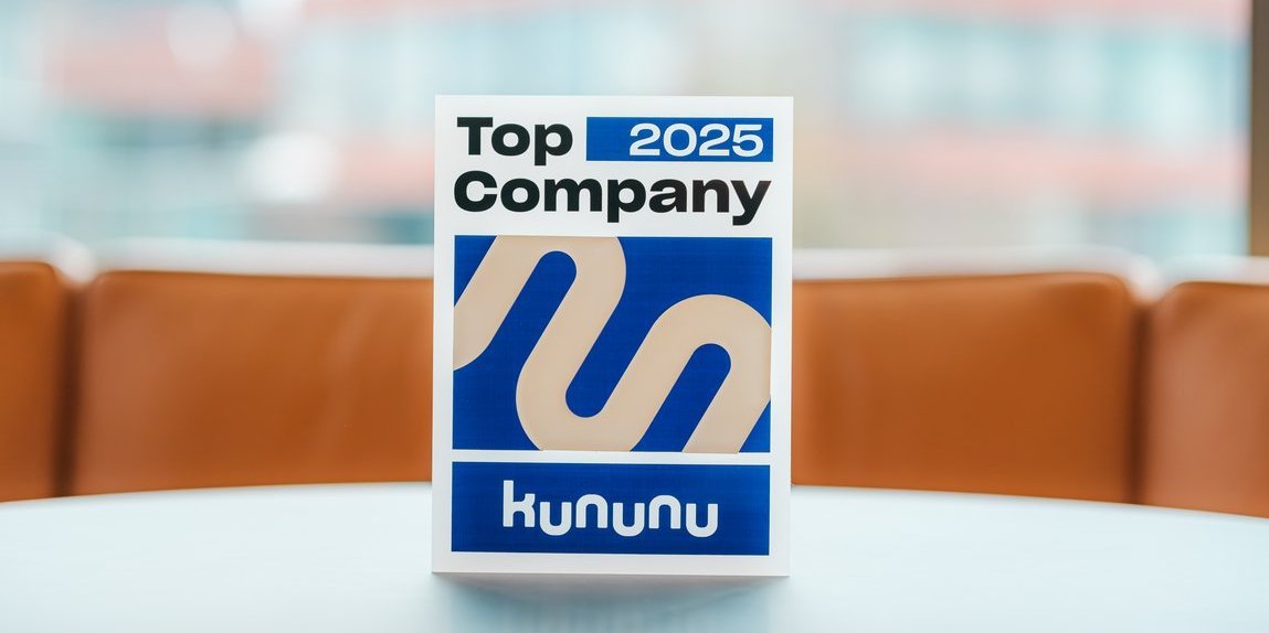 “kununu Top Company 2025” trophy on a table, with a Vector office building in the background.