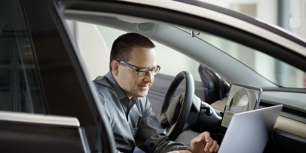 Vector employee performs tests in a car