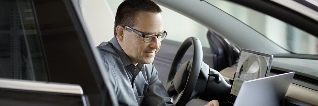 A Vector employee performing tests in a vehicle