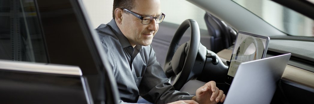 A Vector employee performing tests in a vehicle