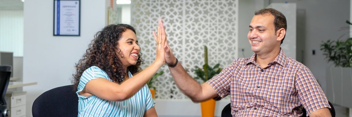 Two Vector employees give each other a high-five