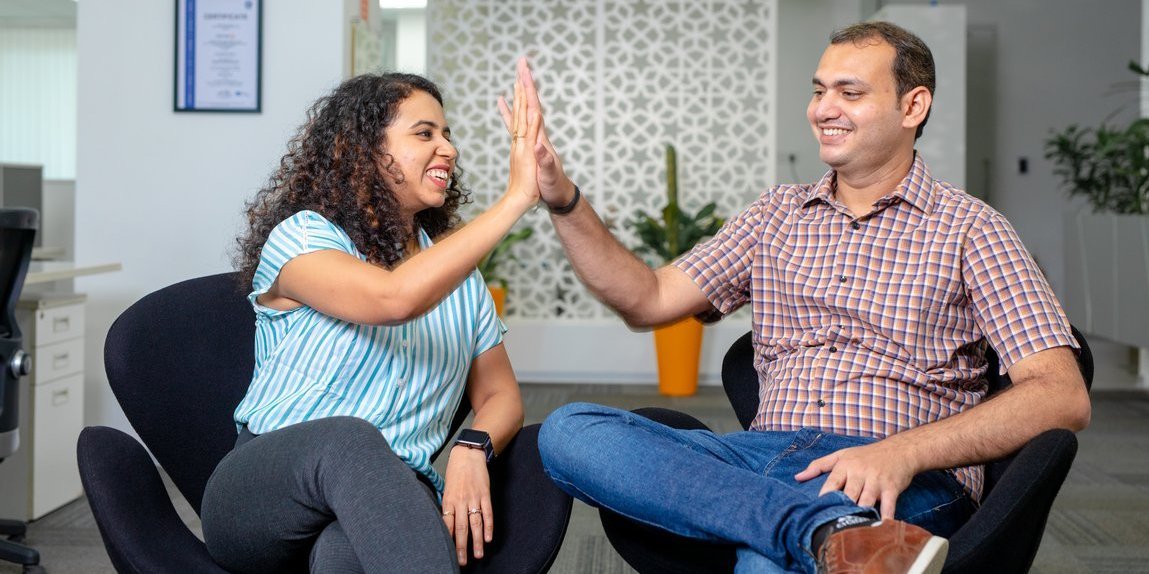 Two Vector employees give each other a high-five